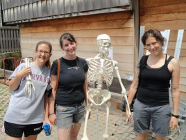 Program Administrator with two interns and model skeleton used for anatomical reference in classes