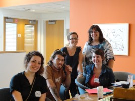 Four interns pose with Program Administrator during orientation