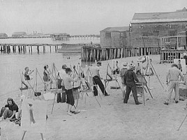 archival image of students in class painting on the beach